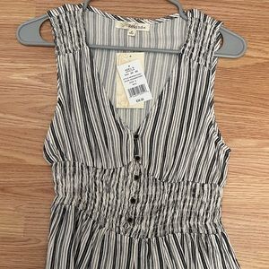 Black and white strapped blouse .